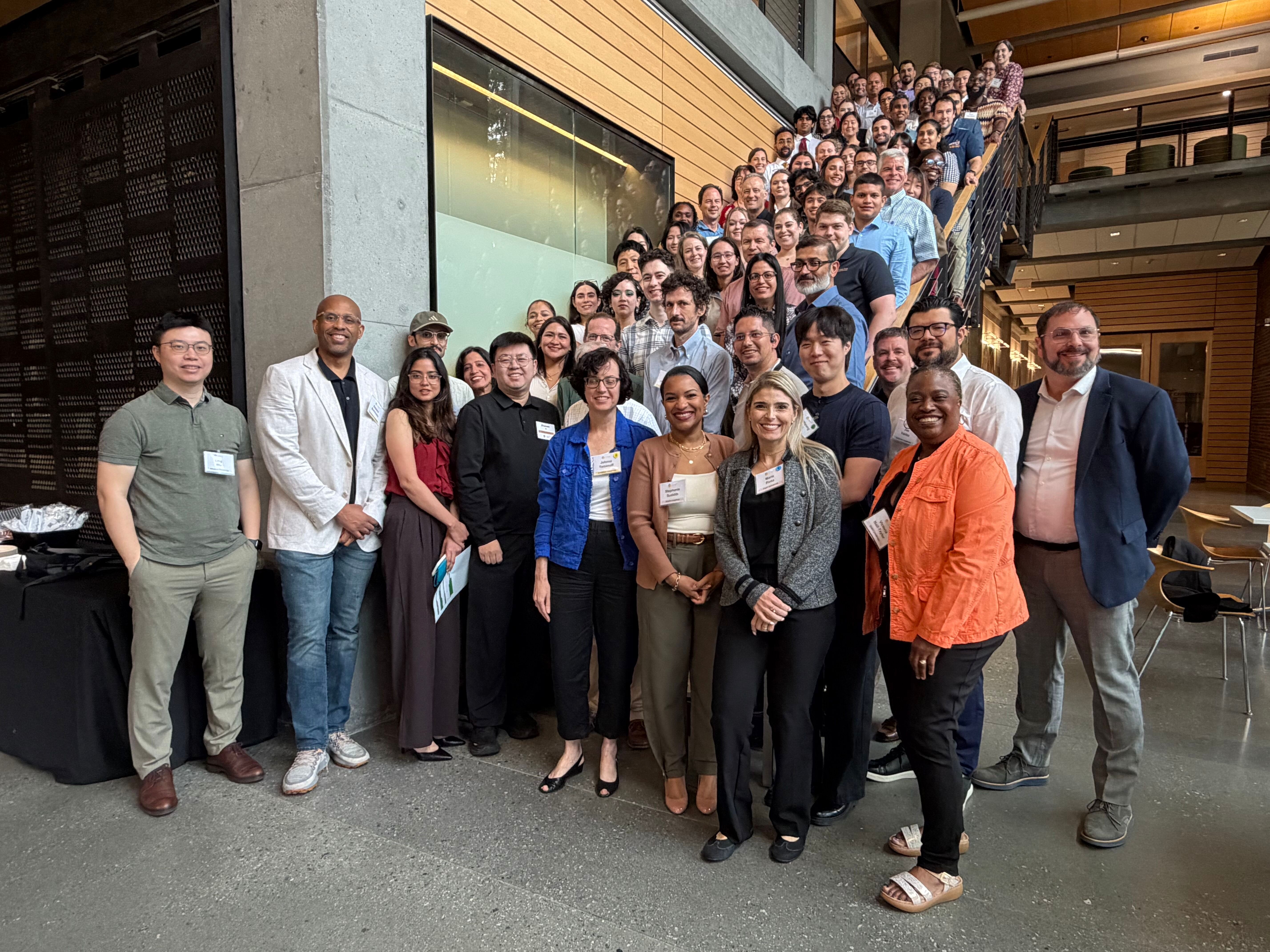 group photo of all attendees taken on a staircase during the event